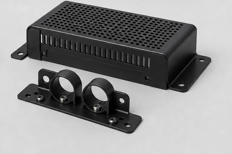 Perforated protective cover and cable brackets for a speaker amplifier module